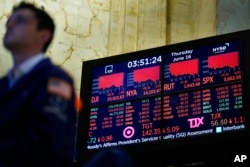 A trader works on the floor at the New York Stock Exchange in New York, June 16, 2022.