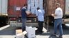 FILE - Customs officials inspect a convoy of humanitarian aid after it crossed into Syria from Turkey through the Bab al-Hawa border crossing, July 8, 2022.