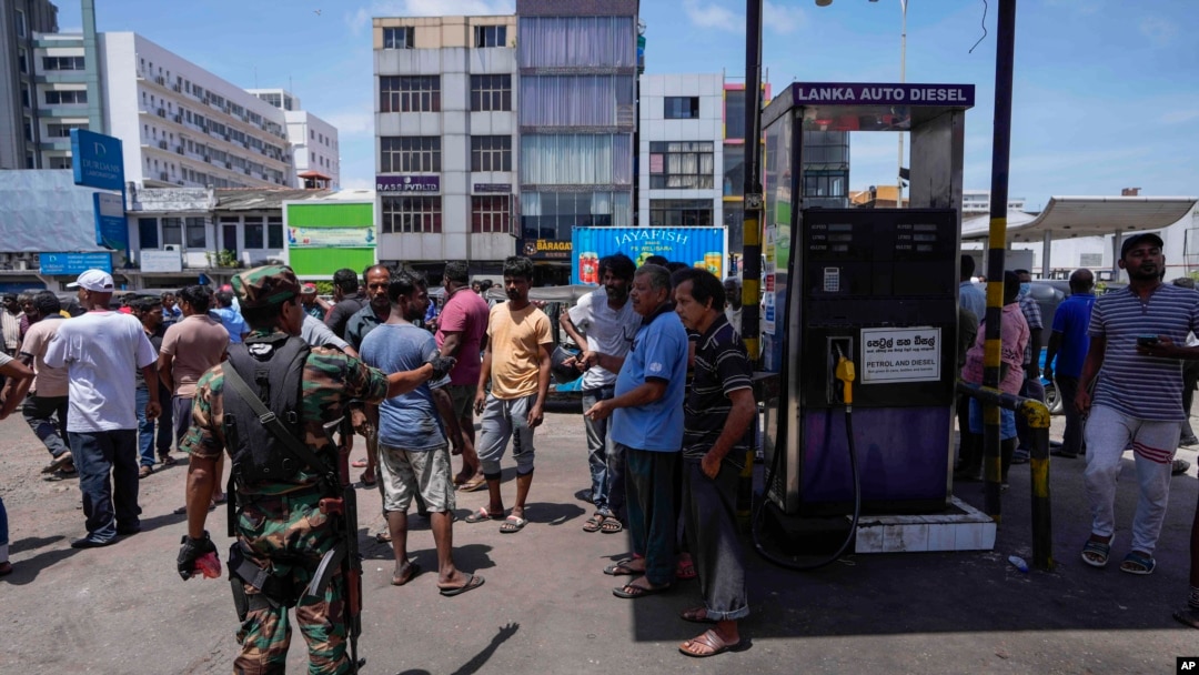 Seorang tentara mencoba menenangkan warga yang menuntut pengadaan BBM di sebuah pompa bensin di Kolombo, Sri Lanka, Senin, 27 Juni 2022. (AP/Eranga Jayawardena)