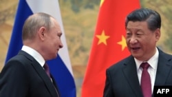 FILE - Russian President Vladimir Putin, left, and Chinese President Xi Jinping pose for a photograph during their meeting in Beijing, on February 4, 2022.