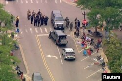 Police deploy after gunfire erupted at a Fourth of July parade route in the Chicago suburb of Highland Park, Illinois, July 4, 2022 in a still image from video. (ABC affiliate WLS/ABC7 via Reuters)