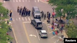 Police deploy after gunfire erupted at a Fourth of July parade route in the Chicago suburb of Highland Park, Illinois, July 4, 2022 in a still image from video. (ABC affiliate WLS/ABC7 via Reuters)