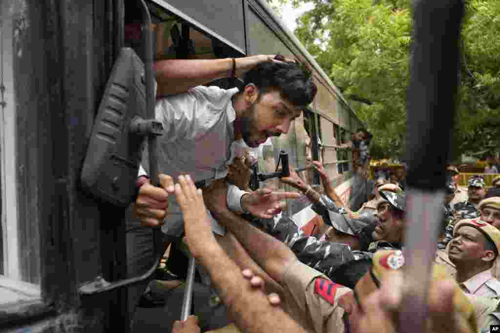 Policemen detain activists from right-wing Hindu parties protesting against the Tuesday killing of Kanhaiya Lal, a Hindu man in a suspected religious attack in western Udaipur city in New Delhi, India.