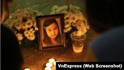 Người dân thắp nến cầu siêu trước tòa nhà Sài Gòn Pearl nơi bé Vân An bị người tình của cha hành hạ đến tử vong hồi tháng 12 năm ngoái.