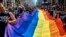 FILE - Reveler carry a LTBGQ flag along Fifth Avenue during the New York City Pride Parade on June 24, 2018, in New York. 
