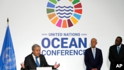 FILE - United Nations Secretary-General Antonio Guterres, left, gestures during a news conference with Portuguese President Marcelo Rebelo de Sousa and Kenya President Uhuru Kenyatta, right, at the U.N. Ocean Conference in Lisbon, June 27, 2022.