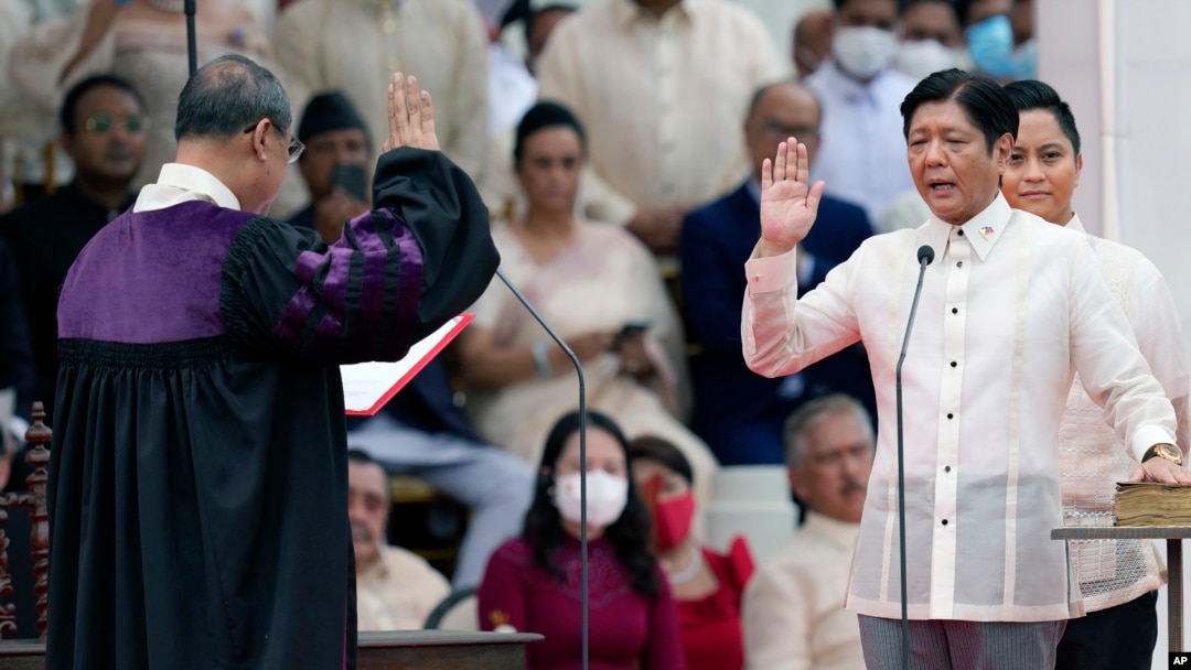President-elect Ferdinand "Bongbong" Marcos Jr., right, is sworn in by Supreme Court Chief Justice Alexander Gesmundo during the inauguration ceremony at National Museum, June 30, 2022 in Manila, Philippines. 