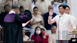 President-elect Ferdinand "Bongbong" Marcos Jr., right, is sworn in by Supreme Court Chief Justice Alexander Gesmundo during the inauguration ceremony at National Museum, June 30, 2022 in Manila, Philippines. 