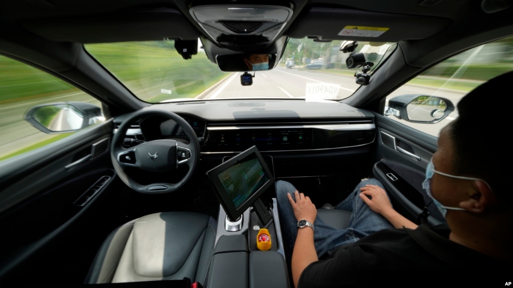 FILE - A technician monitors the self-driving taxi developed by tech giant Baidu Inc. on June 14, 2022, in Beijing, China. (AP Photo/Ng Han Guan)