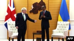 FILE: Britain's Prime Minister Boris Johnson (L) speaks with Rwandan President Paul Kagame ahead of a bilateral meeting at the office of the President in Kigali, on June 23, 2022, on the sidelines of the Commonwealth Heads of Government Meeting (CHOGM)
