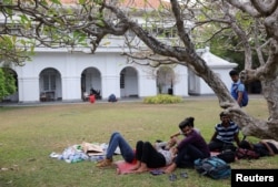 Demonstrators rest in the garden at the Prime Minister's residence on the following day after demonstrators entered the building, amid the country's economic crisis, in Colombo, Sri Lanka, July 10, 2022.