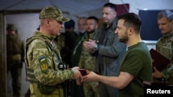 Ukraine's President Volodymyr Zelenskiy awards a Ukrainian serviceman at a position, as Russia's attack on Ukraine continues, outside the southern city of Mykolaiv, Ukraine June 18, 2022.