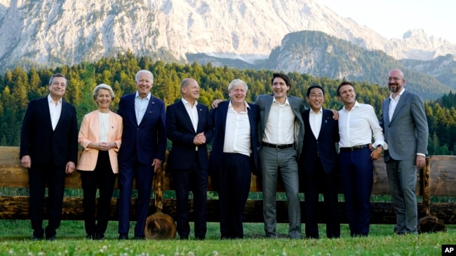 Members of the Group of Seven, including European Union leaders, pose for a photo at Schloss Elmau, following dinner, in Elmau, Germany, June 26, 2022. 