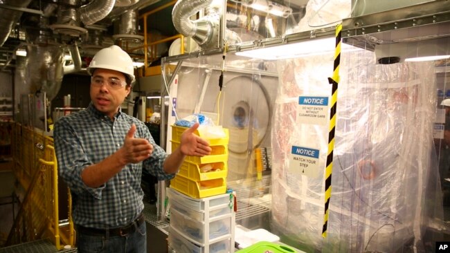 Aaron Manalaysay, the physics coordinator of Lawrence Berkeley National Lab's experiment, explains how the underground detector will interact with dark matter in the Sanford Underground Research Facility in Lead, S.D., on Dec. 8, 2019. (AP Photo/Stephen Groves)