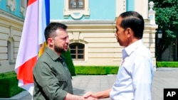 In this photo released by Indonesian Presidential Palace, Indonesian President Joko Widodo, right, shakes hands with his Ukrainian counterpart, Volodymyr Zelenskyy, during their meeting in Kyiv, Ukraine, June 29, 2022.