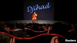 Belgian playwright and actor Ismael Saidi sits on stage after a presentation of his play "Jihad" to speak to students in the audience at a theater in Valenciennes, France, Jan. 4, 2017. 