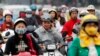 FILE - A motorist talks on his mobile phone while waiting at a traffic junction in Hanoi, Oct, 31, 2011. 