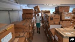 Cose di Maglia factory's storekeeper Malik goes through boxes of unsold D.Exterior clothes intended for Moscow's stores, in Brescia, Italy, June 14, 2022.
