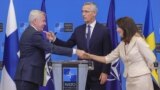 Finnish Foreign Minister Pekka Haavisto, left, and Swedish Foreign Minister Ann Linde, right, attend a news conference with NATO Secretary General Jens Stoltenberg center in background, following the signing of NATO accession protocols for Sweden and Finl