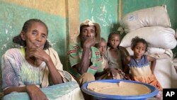 Tesfay sits with his wife and grandchildren, who have been displaced, as they receive food assistance for the first time in 8 months from the World Food Program (WFP), in Mehameday, in the Tigray region of Ethiopia. Taken 5.28.2022