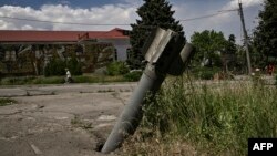 The tail of a rocket is nailed into pavement in the city of Lysychansk at the eastern Ukrainian region of Donbas, as the Russian-Ukraine war enters its 114th day.