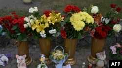 A picture shows candles, flowers and children toys next to a destroyed mall in Kremenchuk, on June 28, 2022, the day after it was hit by a Russian missile strike according to Ukrainian authorities.