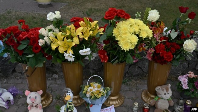 A picture shows candles, flowers and children toys next to a destroyed mall in Kremenchuk, on June 28, 2022, the day after it was hit by a Russian missile strike according to Ukrainian authorities.