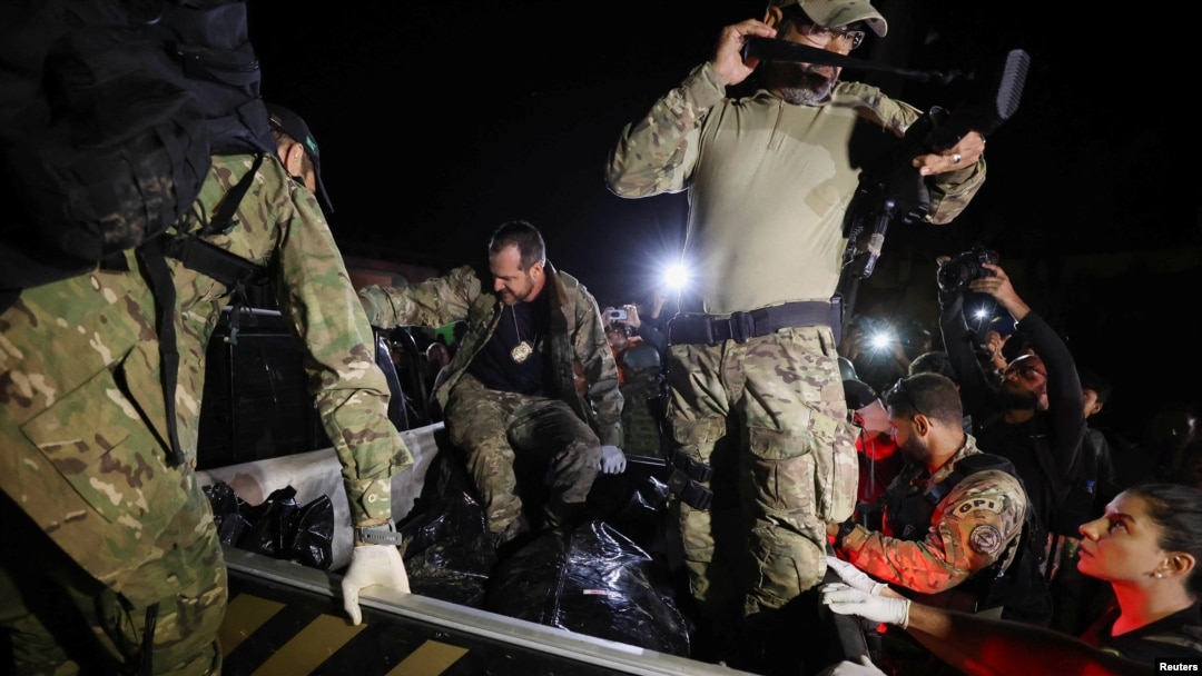 Federal Police officers transport body bags after a suspect confessed to killing British journalist Dom Phillips and Brazilian indigenous expert Bruno Pereira and led police to the location of human remains, in Atalaia do Norte, Amazonas state, Brazil, Ju