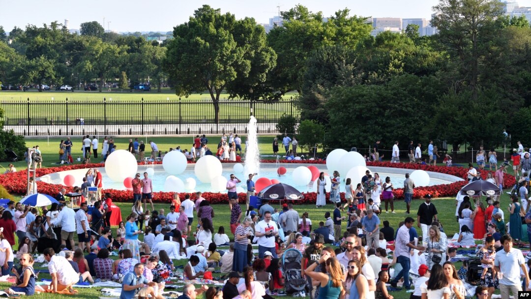 Guests picnic on the South Lawn of the White House during a 4th of July BBQ with military families in Washington, July 4, 2022.