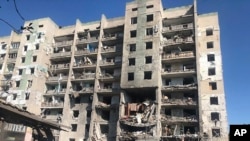 In this photo provided by the Odesa Regional Prosecutor's Office, a damaged residential building is seen in Odesa, Ukraine, early, July 1, 2022, following Russian missile attacks.