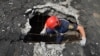 Ukrainian rescuers search for and retrieve the remains of Russian shells on the roof of a high-rise building damaged by Russian shelling in one of the residential areas of Kharkiv, Ukraine, June 30, 2022. 