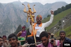 A Hindu devotee is carried by porters during his pilgrimage from Baltal Base Camp to the holy Amarnath Cave Shrine in India. (Photo by Wasim Nabi)