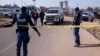 FILE — South African Police Service (SAPS) officers enforce a perimeter around a crime scene as pathalogical investigators inspect the crime scene where 14 people where shot dead in a tavern, in Soweto, on July 10, 2022. 