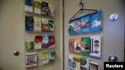 FILE - Information pamphlets hang on the back of a door in a procedure room at the Women's Health Clinic, which offers reproductive care, including abortions, in Winnipeg, Manitoba, June 28, 2022.