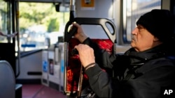 A man rides a bus through the streets of Sydney, Australia, June 17, 2022. 