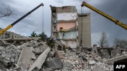 Rescuers clear the scene after a building was partially destroyed as a result of Russian missile hit on a four-story residential building in Chasiv Yar, Bakhmut District, eastern Ukraine, on July 10, 2022. 