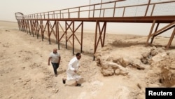 Iraqis visit an area near the pond remaining of Lake Sawa, due to climate change-induced drought, in Samawa city, Iraq May 1, 2022. (REUTERS/Alaa Al-Marjani)