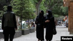 Afghan women walk on a street in Kabul, Afghanistan, May 9, 2022.