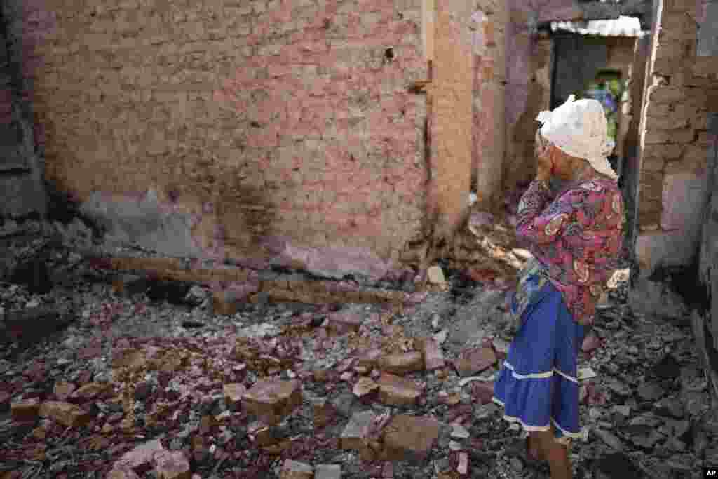 Hanna Sylivon, 76, reacts inside her house destroyed by attacks in Chernihiv, Ukraine.