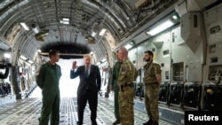 British Prime Minister Boris Johnson speaks to squadron leaders aboard a C17 after arriving at RAF Brize Norton, following a surprise visit to meet with Ukrainian President Volodymyr Zelensky in Kyiv, Ukraine, in Oxfordshire, England, June 18, 2022.