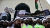 Activists and supporters hold placards as they gather outside the Baitul Mukarram National mosque before marching toward the Indian Embassy in Dhaka on June 16, 2022, to protest remarks about the Prophet Muhammad by Indian ruling party members.