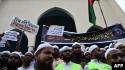 Activists and supporters hold placards as they gather outside the Baitul Mukarram National mosque before marching toward the Indian Embassy in Dhaka on June 16, 2022, to protest remarks about the Prophet Muhammad by Indian ruling party members.