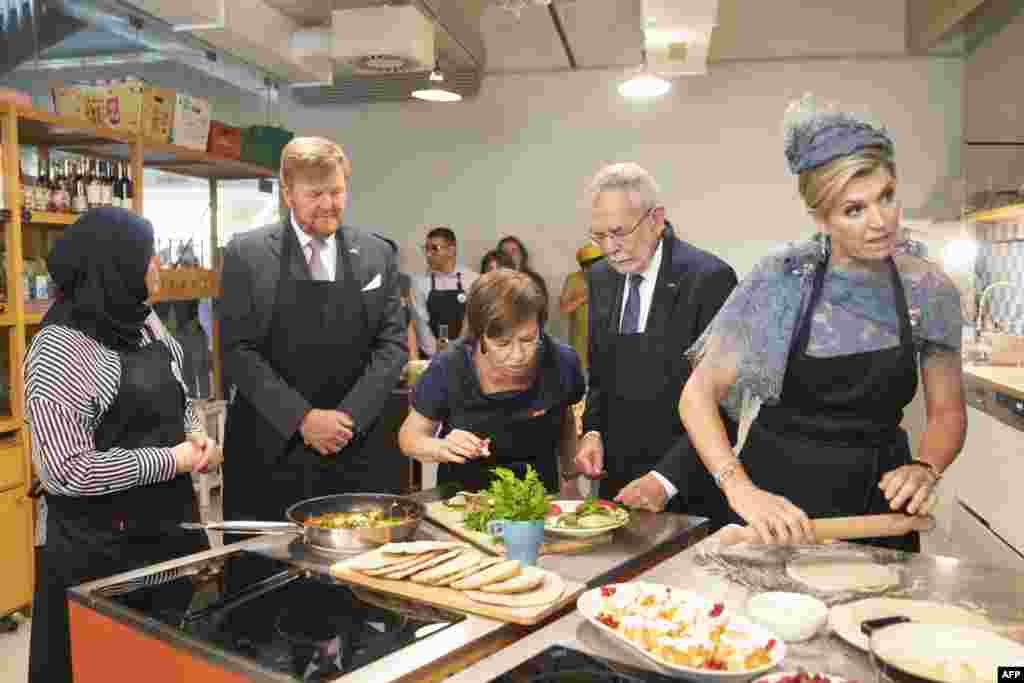 King Willem-Alexander of the Netherlands (2nd L) and Queen Maxima of the Netherlands (R), together with Austrian President Alexander Van der Bellen (2nd R) and his wife Doris Schmidauer (C), visit the &quot;Community Cooking&quot; project of Caritas in Vienna, Austria.