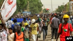 FILE: People march during a demonstration against military rule in the Bashdar area of el-Diam district of Sudan's capital Khartoum on June 16, 2022. - Sudanese security forces killed a protester that day in Omdurman during the latest rallies against last year's military coup.