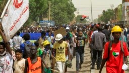 FILE: People march during a demonstration against military rule in the Bashdar area of el-Diam district of Sudan's capital Khartoum on June 16, 2022. - Sudanese security forces killed a protester that day in Omdurman during the latest rallies against last year's military coup.