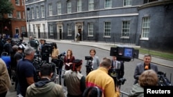 Members of the media wait outside 10 Downing Street, where British Prime Minister Boris Johnson is expected to make a statement, in London, July 7, 2022. 