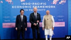 FILE -- From left, Japanese Prime Minister Fumio Kishida, U.S. President Joe Biden and Indian Prime Minister Narendra Modi pose for photos as they arrive at the Indo-Pacific Economic Framework for Prosperity launch event at the Izumi Garden Gallery in Tok