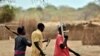 Trainee soldiers for a new unified army carry wooden rifles while attending a reconciliation programme run by the United Nations Mission in South Sudan (UNMISS) at a makeshift barracks in Mapel on January 31, 2020.