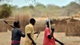 Trainee soldiers for a new unified army carry wooden rifles while attending a reconciliation programme run by the United Nations Mission in South Sudan (UNMISS) at a makeshift barracks in Mapel on January 31, 2020.