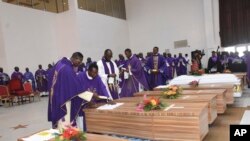  FILE - Mourners pay theirs respects to the victims killed at the St. Francis Catholic Church on June 5, during a funeral service in Owo, Southwest of Nigeria, June 17, 2022. 